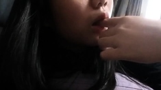 Asian girl fucks herself with a cream tube on a webcam